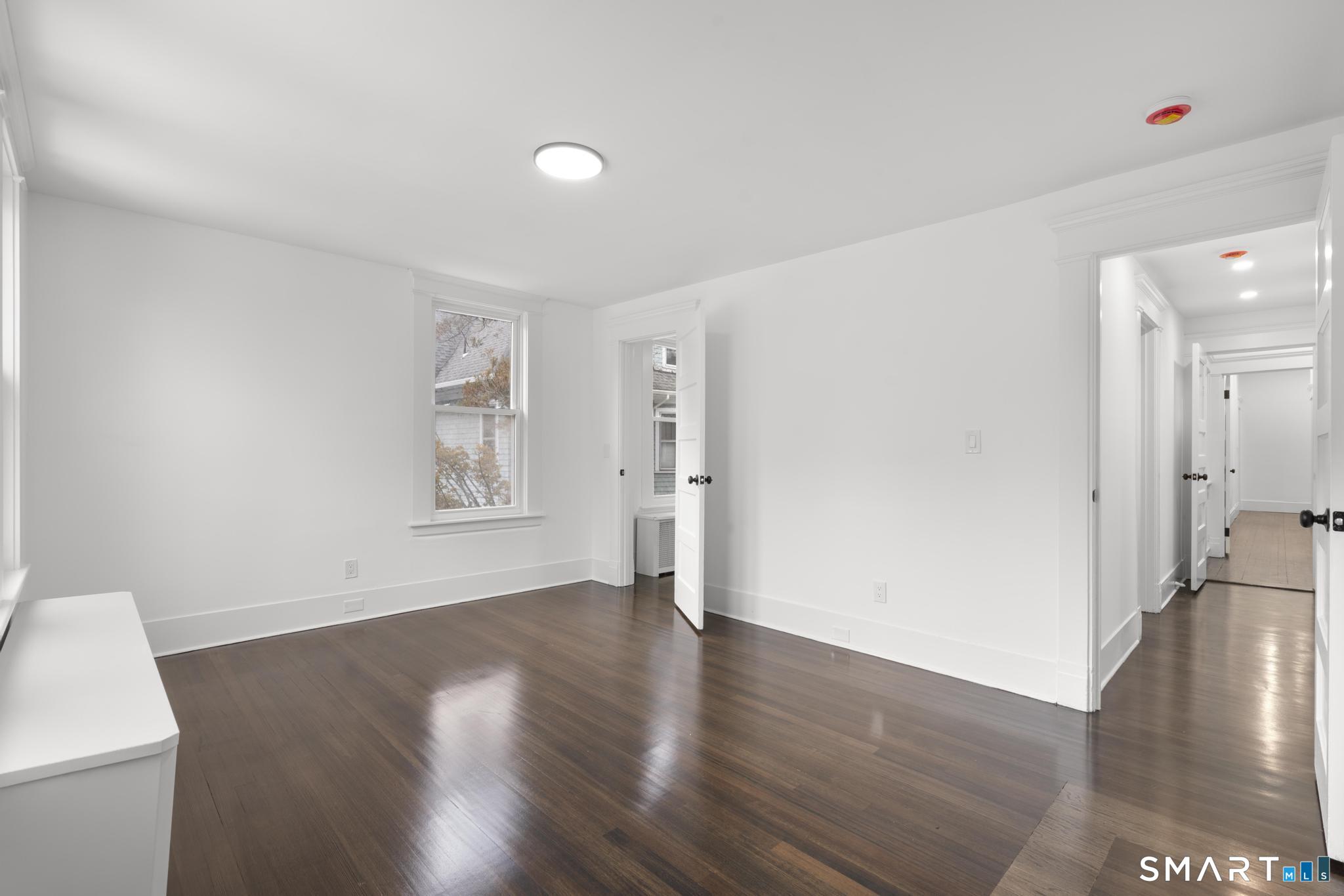 74 Cold Spring Street New Haven, CT 06511 - Photo 18 of 40 a view of an empty room with wooden floor and a window