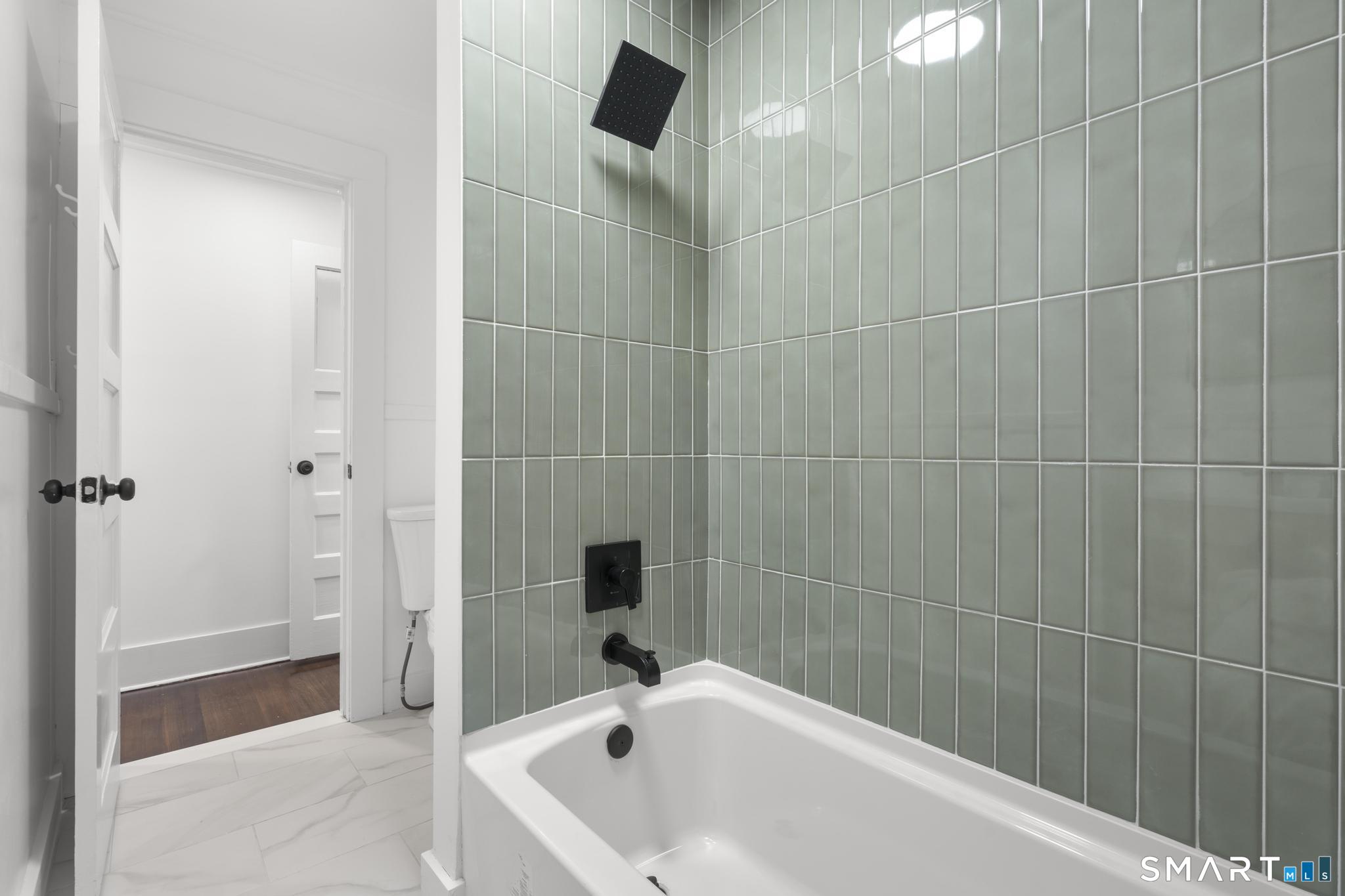 74 Cold Spring Street New Haven, CT 06511 - Photo 19 of 40 a bathroom with a bathtub and shower