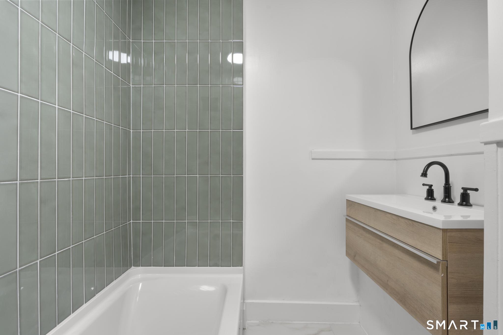 74 Cold Spring Street New Haven, CT 06511 - Photo 20 of 40 a bathroom with a sink a toilet and shower