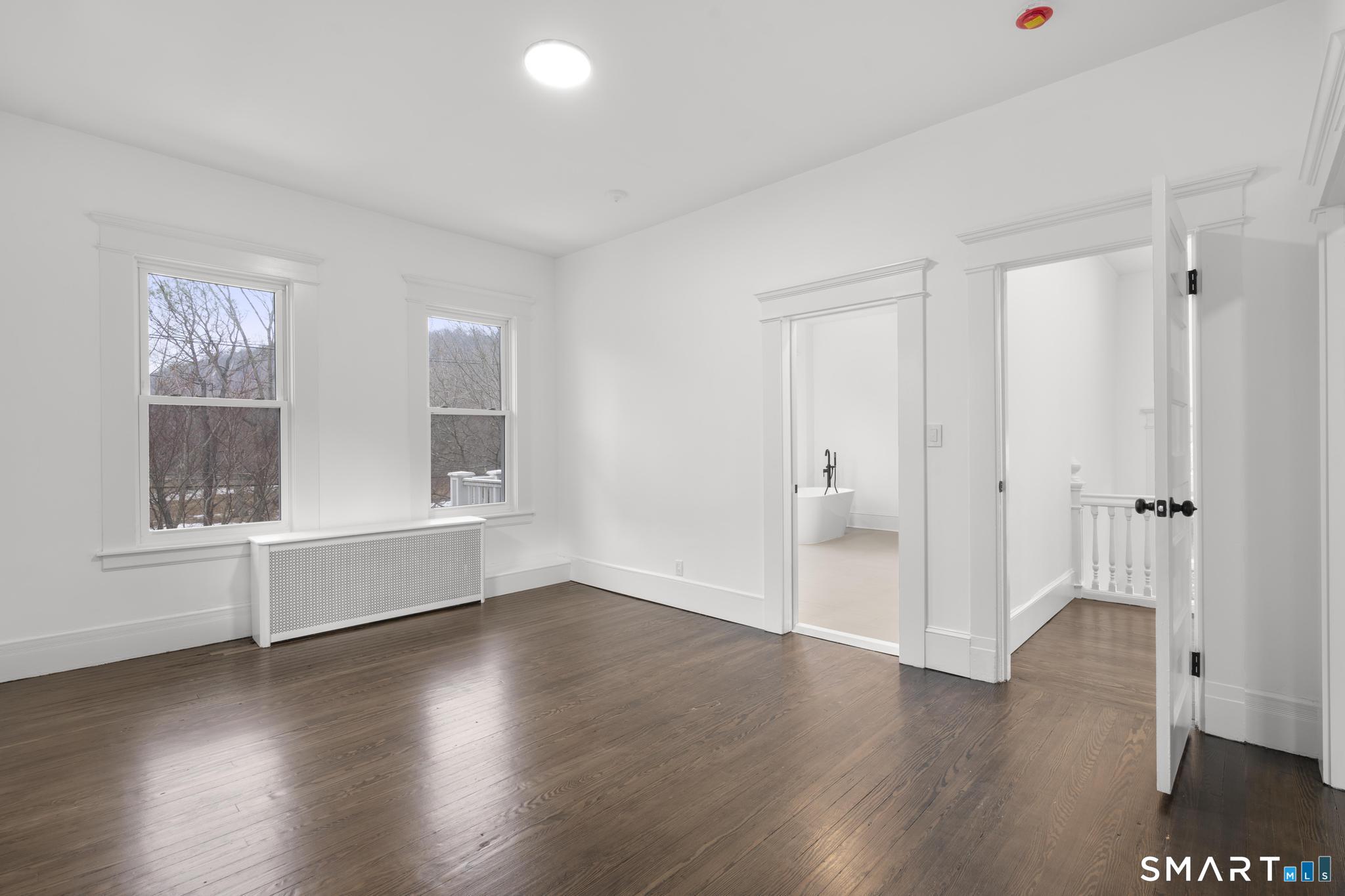 74 Cold Spring Street New Haven, CT 06511 - Photo 25 of 40 an empty room with wooden floor and windows