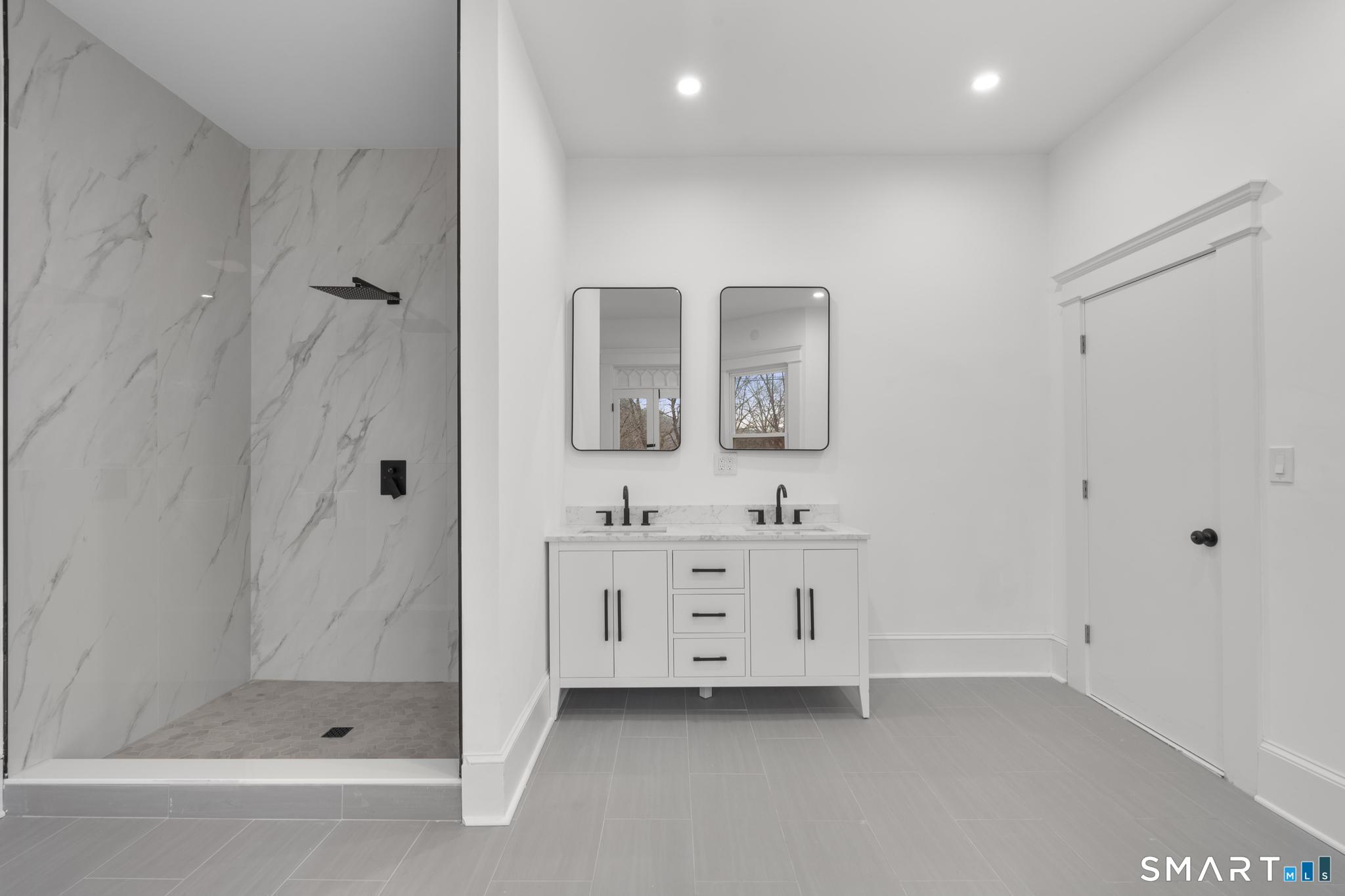 74 Cold Spring Street New Haven, CT 06511 - Photo 27 of 40 a bathroom with a double vanity sink toilet and shower