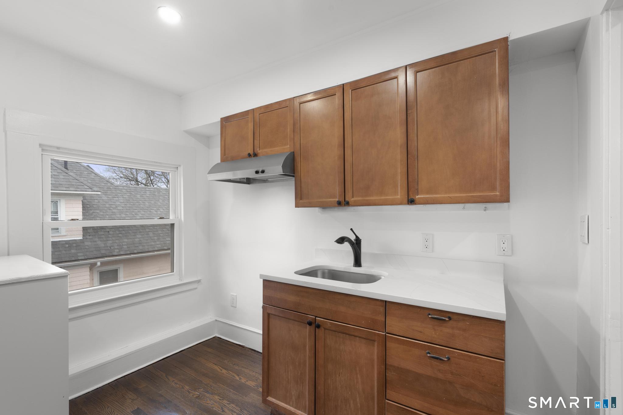 74 Cold Spring Street New Haven, CT 06511 - Photo 31 of 40 a kitchen with a sink and cabinets