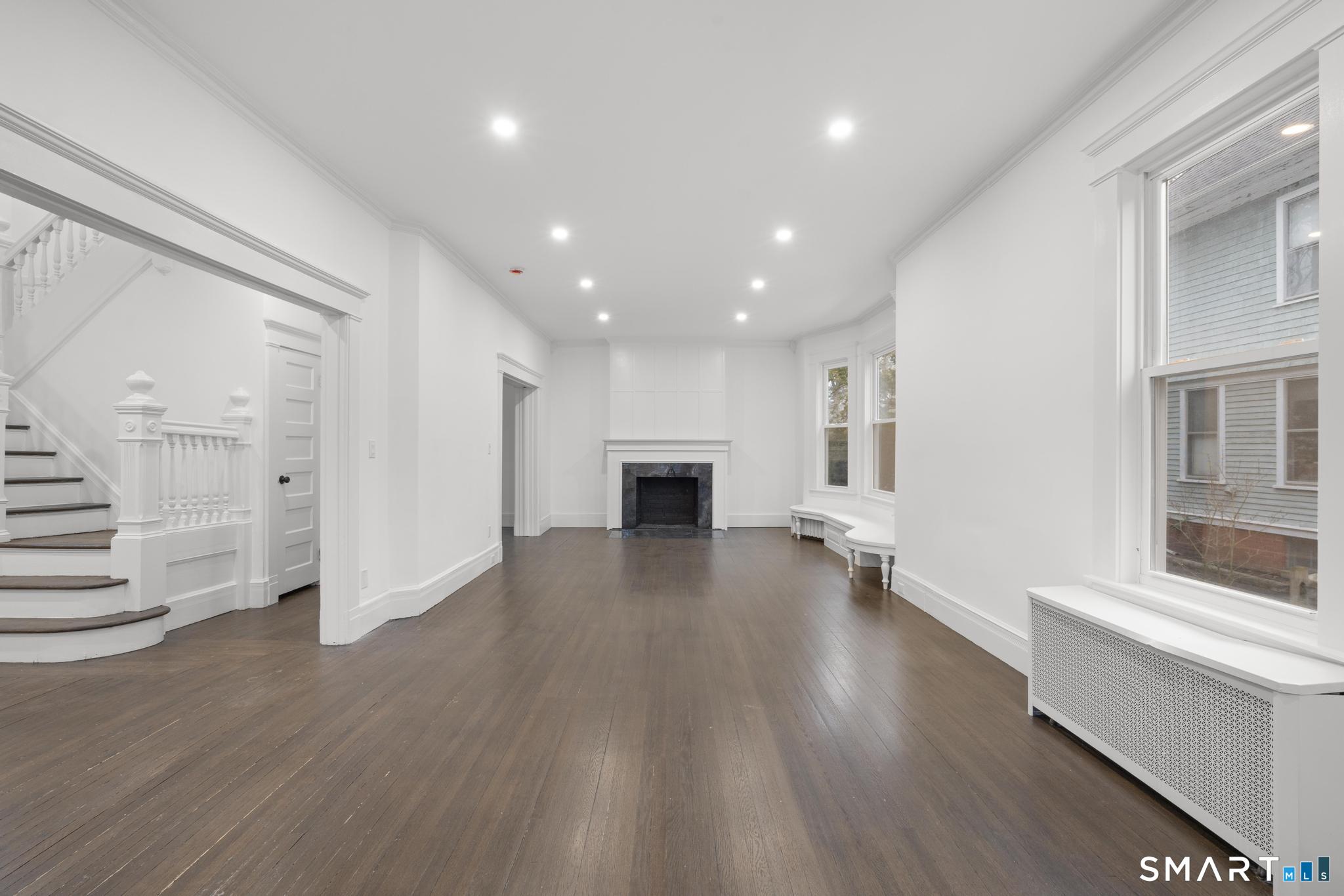 74 Cold Spring Street New Haven, CT 06511 - Photo 5 of 40 an empty room with wooden floor and windows