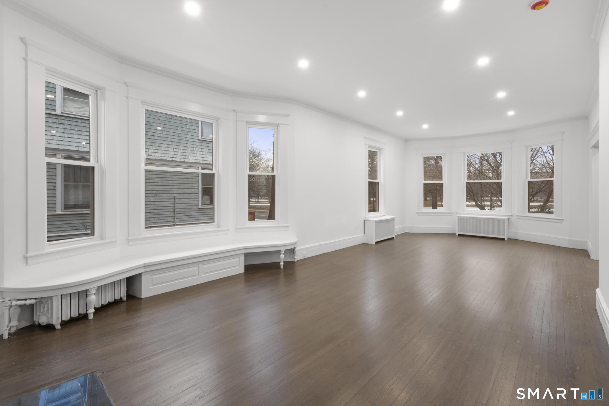 74 Cold Spring Street New Haven, CT 06511 - Photo 7 of 40 a view of an empty room with wooden floor and a window