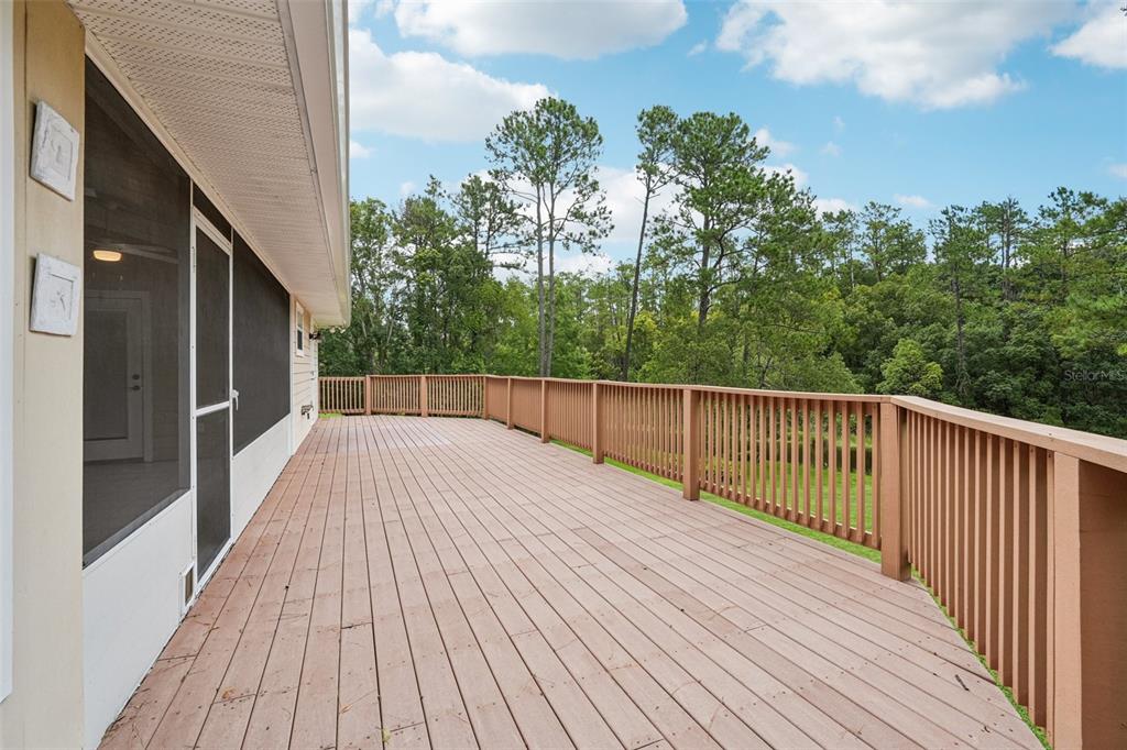 2342 Robert D Road Mount Dora, FL 32757 - Photo 15 of 44 a view of a balcony with wooden floor and fence