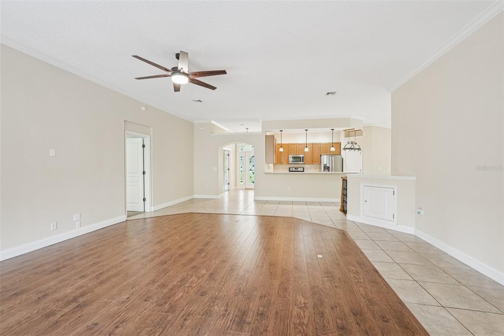 2342 Robert D Road Mount Dora, FL 32757 - Photo 17 of 44 an empty room with wooden floor ceiling fan and windows