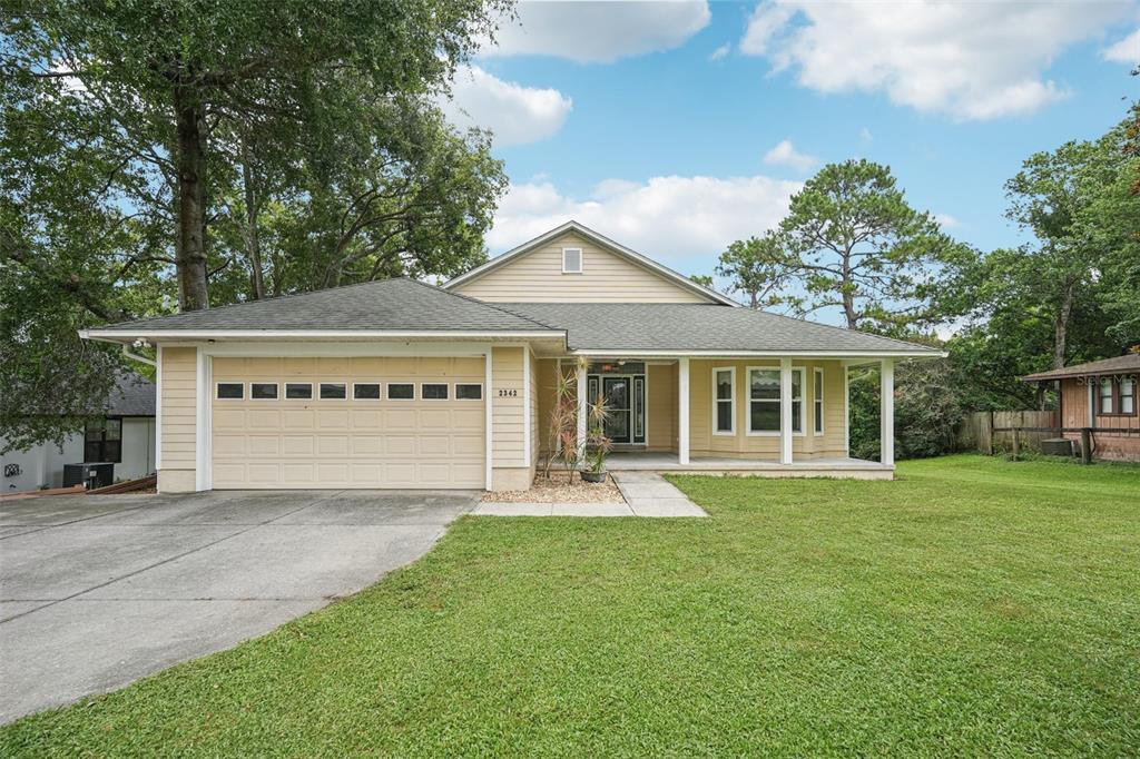 2342 Robert D Road Mount Dora, FL 32757 - Photo 2 of 44 a view of a house with a yard and sitting area
