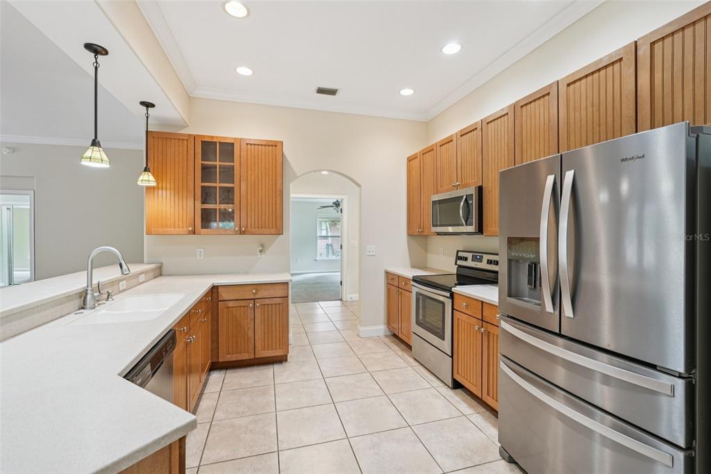 2342 Robert D Road Mount Dora, FL 32757 - Photo 21 of 44 a kitchen with stainless steel appliances granite countertop a refrigerator a stove and a sink