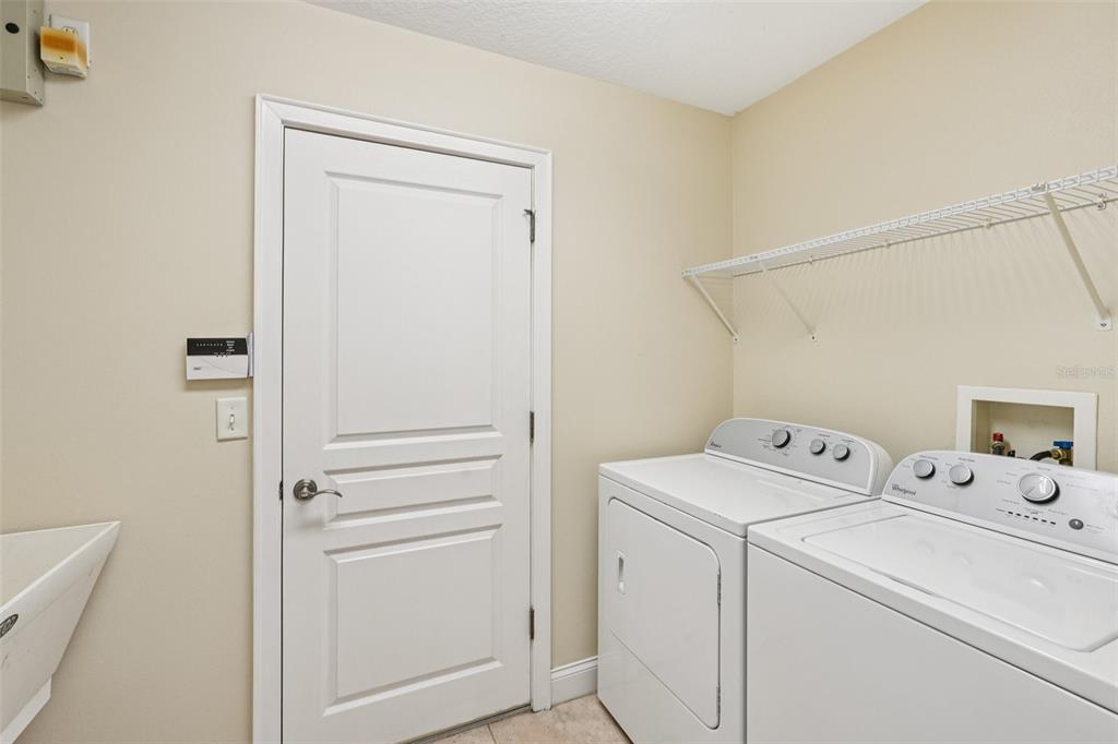 2342 Robert D Road Mount Dora, FL 32757 - Photo 23 of 44 a view of storage and utility room with washer and dryer
