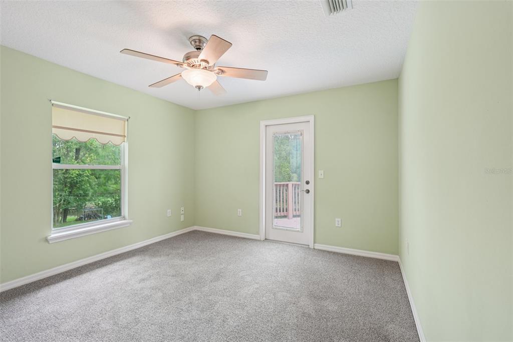 2342 Robert D Road Mount Dora, FL 32757 - Photo 25 of 44 an empty room with fan and windows