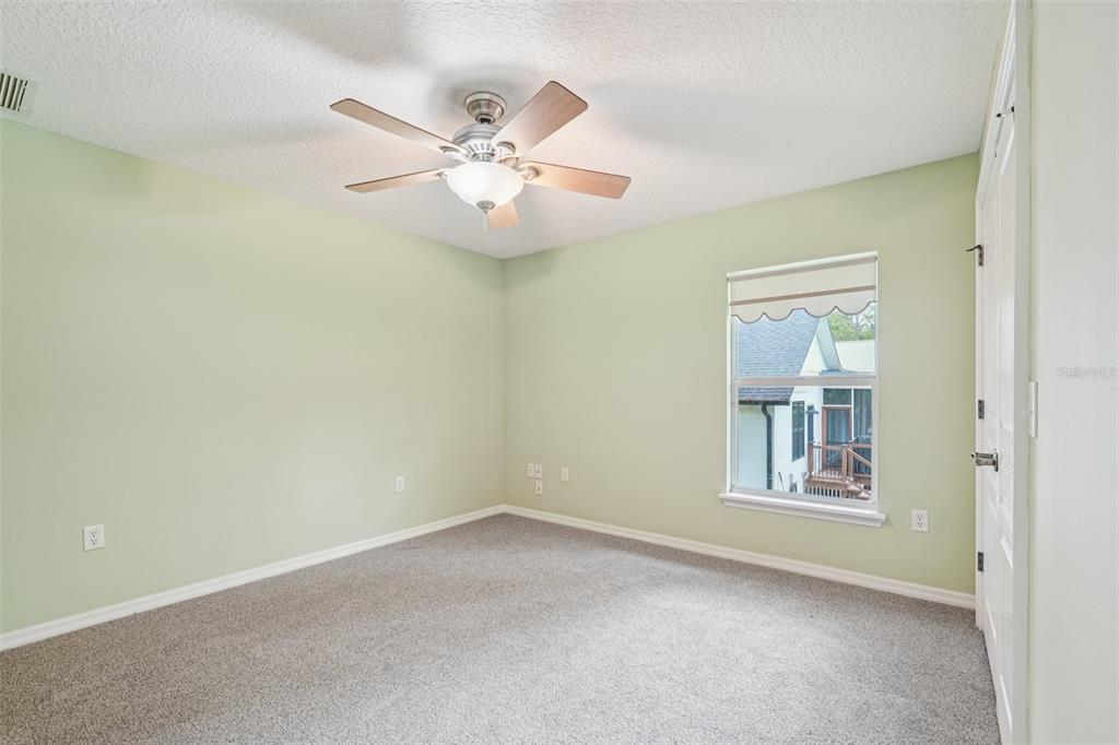2342 Robert D Road Mount Dora, FL 32757 - Photo 28 of 44 an empty room with windows and fan