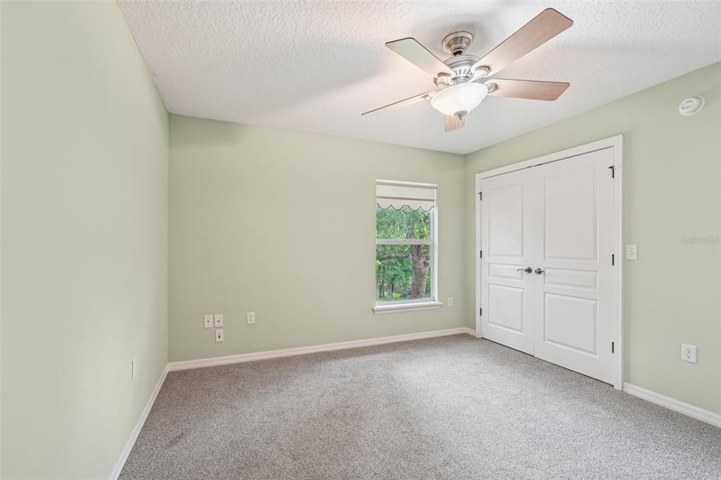 2342 Robert D Road Mount Dora, FL 32757 - Photo 29 of 44 an empty room with fan and windows