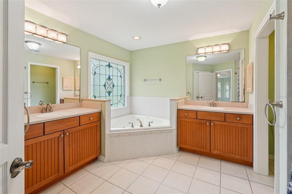 2342 Robert D Road Mount Dora, FL 32757 - Photo 30 of 44 a spacious bathroom with a double vanity sink mirror and bathtub