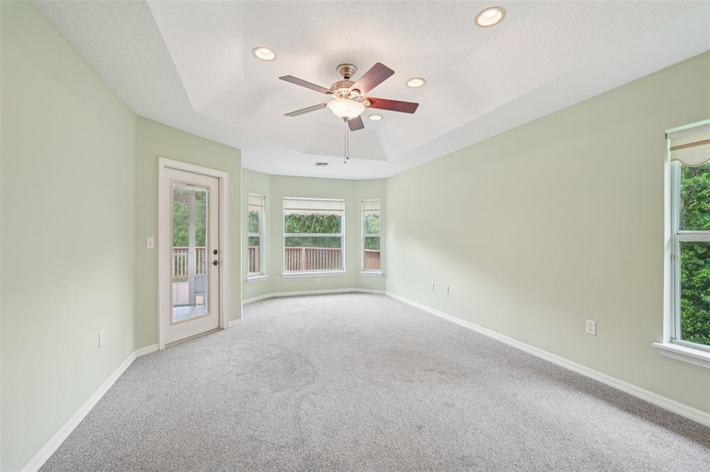2342 Robert D Road Mount Dora, FL 32757 - Photo 32 of 44 an empty room with windows and fan