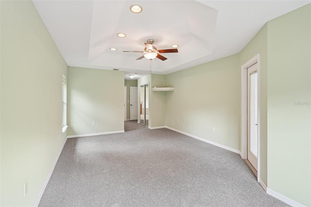2342 Robert D Road Mount Dora, FL 32757 - Photo 33 of 44 an empty room with ceiling fan and window