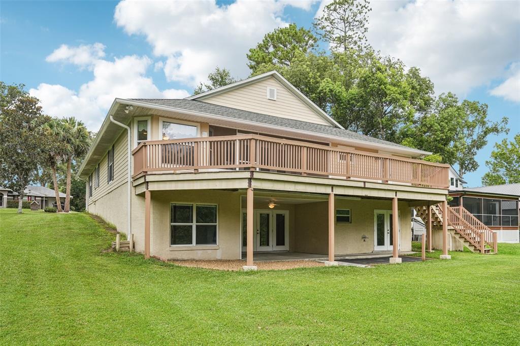 2342 Robert D Road Mount Dora, FL 32757 - Photo 7 of 44 a front view of a house with a garden