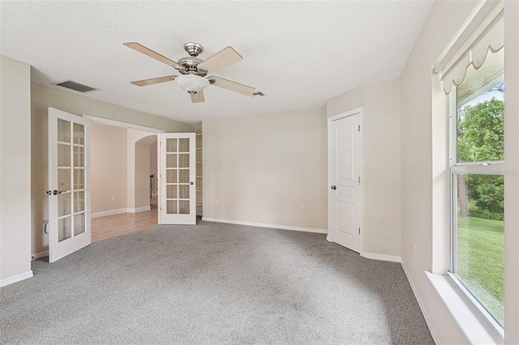 2342 Robert D Road Mount Dora, FL 32757 - Photo 10 of 44 a view of an empty room with a window