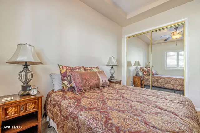 a bedroom with a bed and a mirror