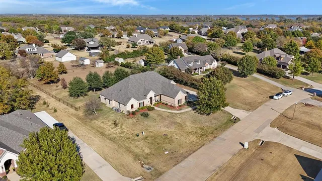 an aerial view of a house with a mountain