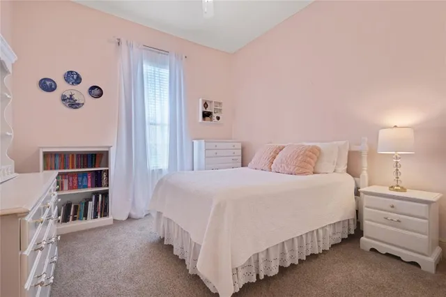 a bedroom with a bed and a book shelf
