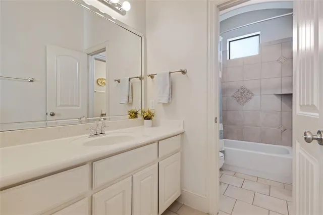 a bathroom with a sink and a mirror with bathtub