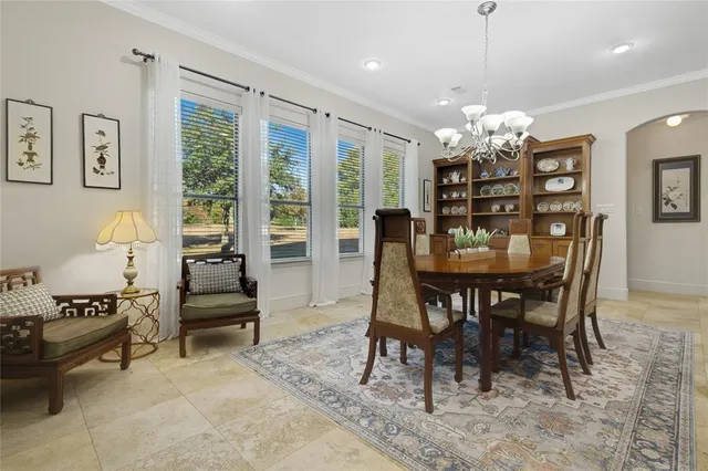 a view of a dining room with furniture a livingroom and chandelier