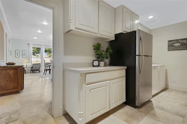 a kitchen with a refrigerator sink and cabinets