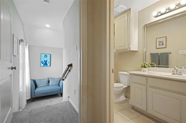 a en suite bathroom with a toilet a sink and a mirror