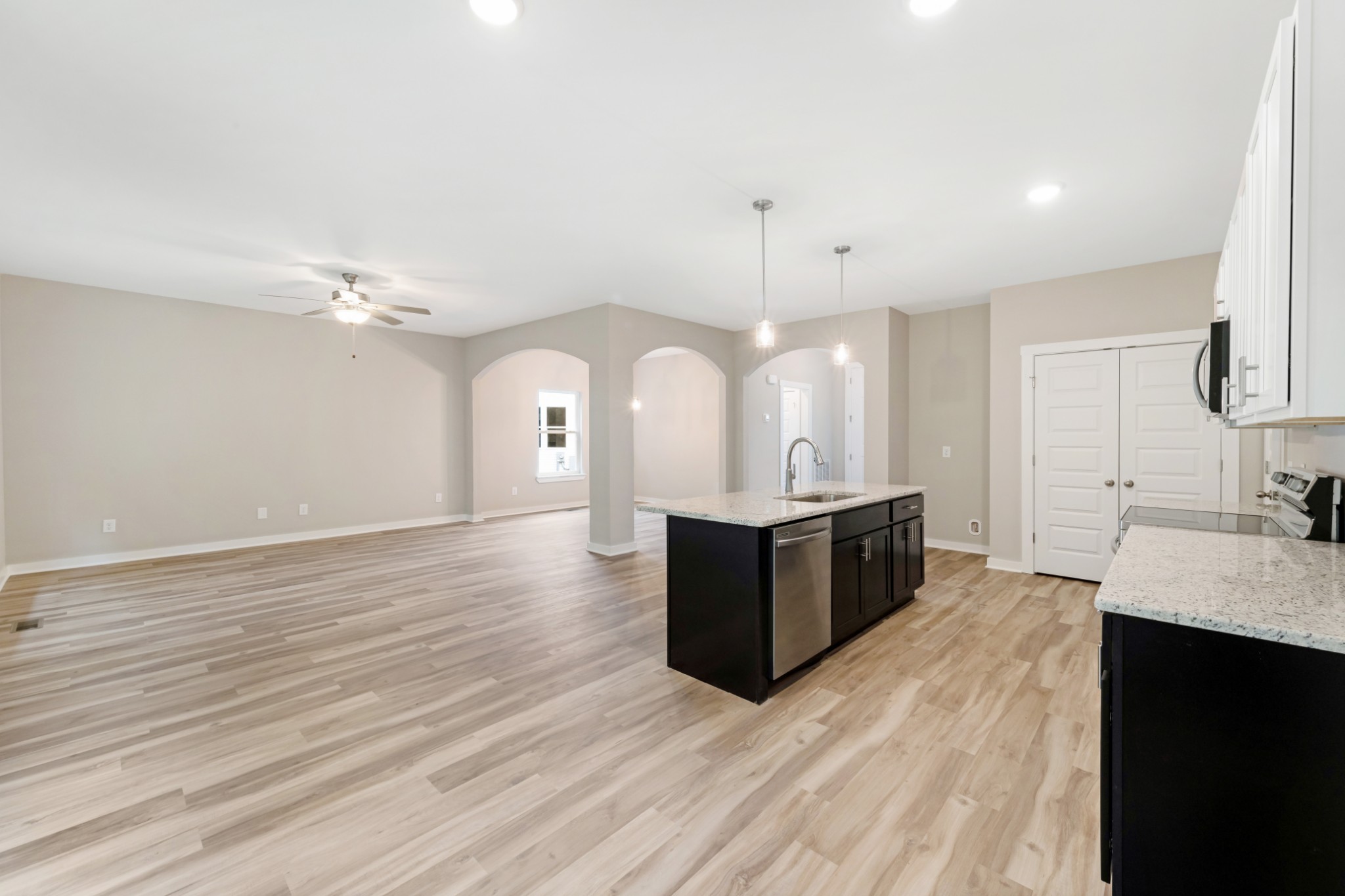 2074 Morgan Court Springfield, TN 37172 - Photo 11 of 20 a large kitchen with a large counter top a sink dishwasher and a fireplace with wooden floor