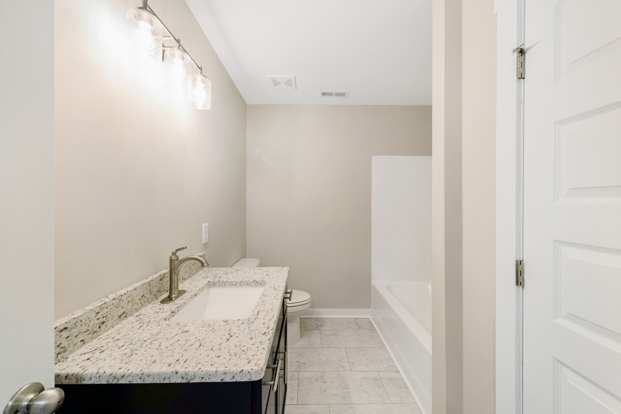 2074 Morgan Court Springfield, TN 37172 - Photo 16 of 20 a bathroom with a granite countertop sink and a mirror