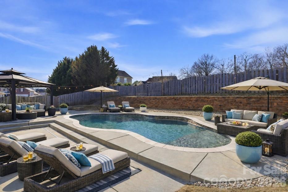 a view of swimming pool with outdoor seating and city view