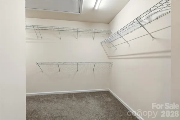 an empty room with a ceiling fan and a window