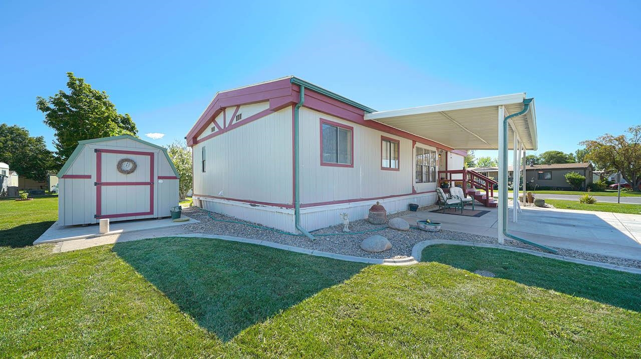 a view of an house with backyard and patio