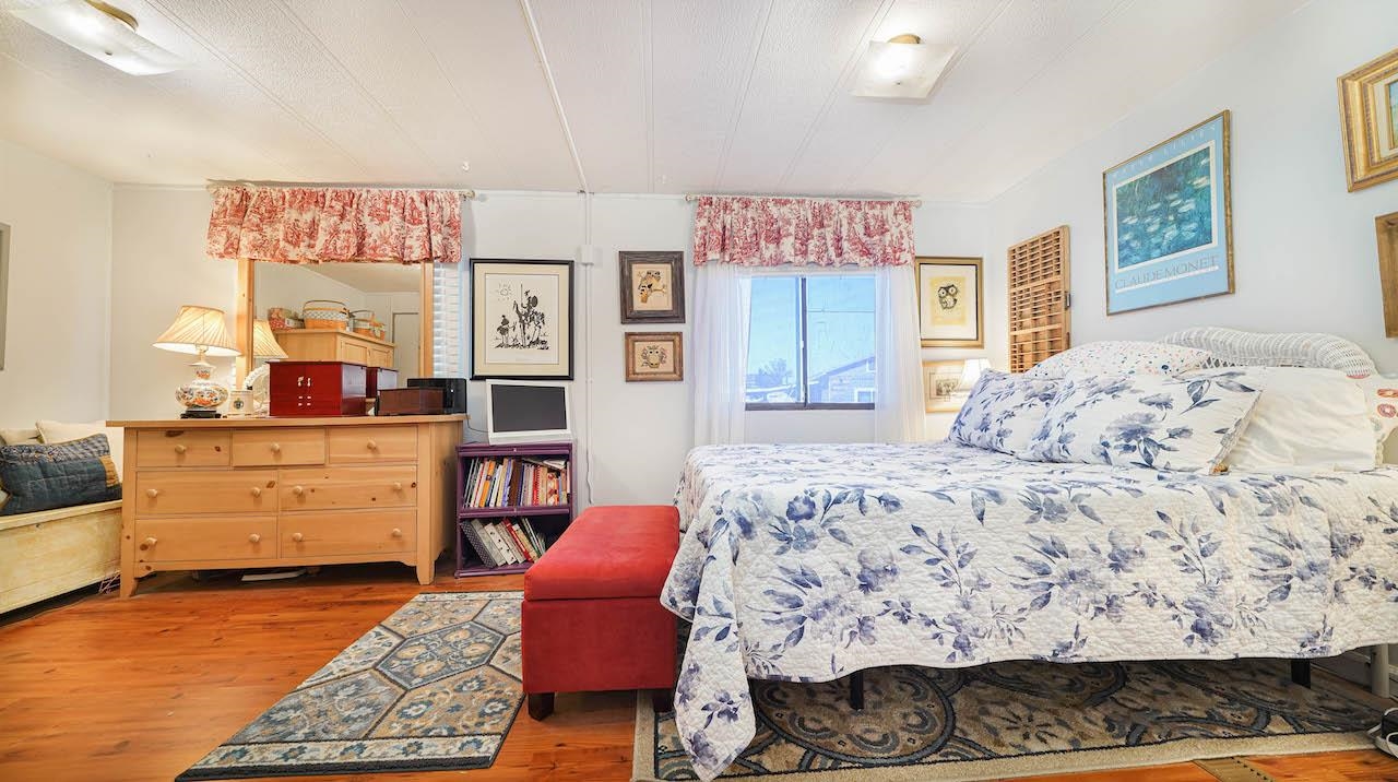 3251 E Road, Unit 100 Clifton, CO 81520 - Photo 14 of 22 a bed room with a bed and a dresser