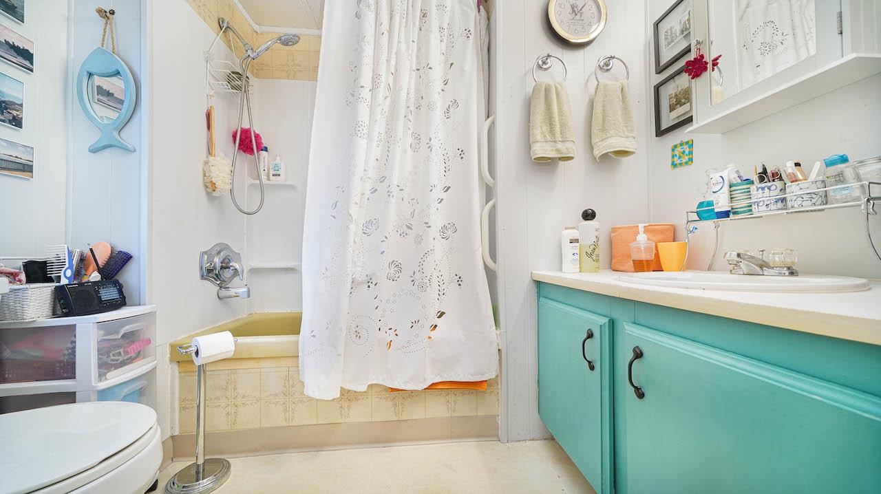 3251 E Road, Unit 100 Clifton, CO 81520 - Photo 15 of 22 a bathroom with a sink mirror vanity and toilet