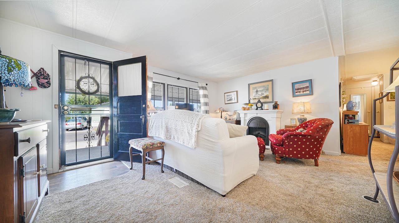 3251 E Road, Unit 100 Clifton, CO 81520 - Photo 2 of 22 a living room with furniture and a large window