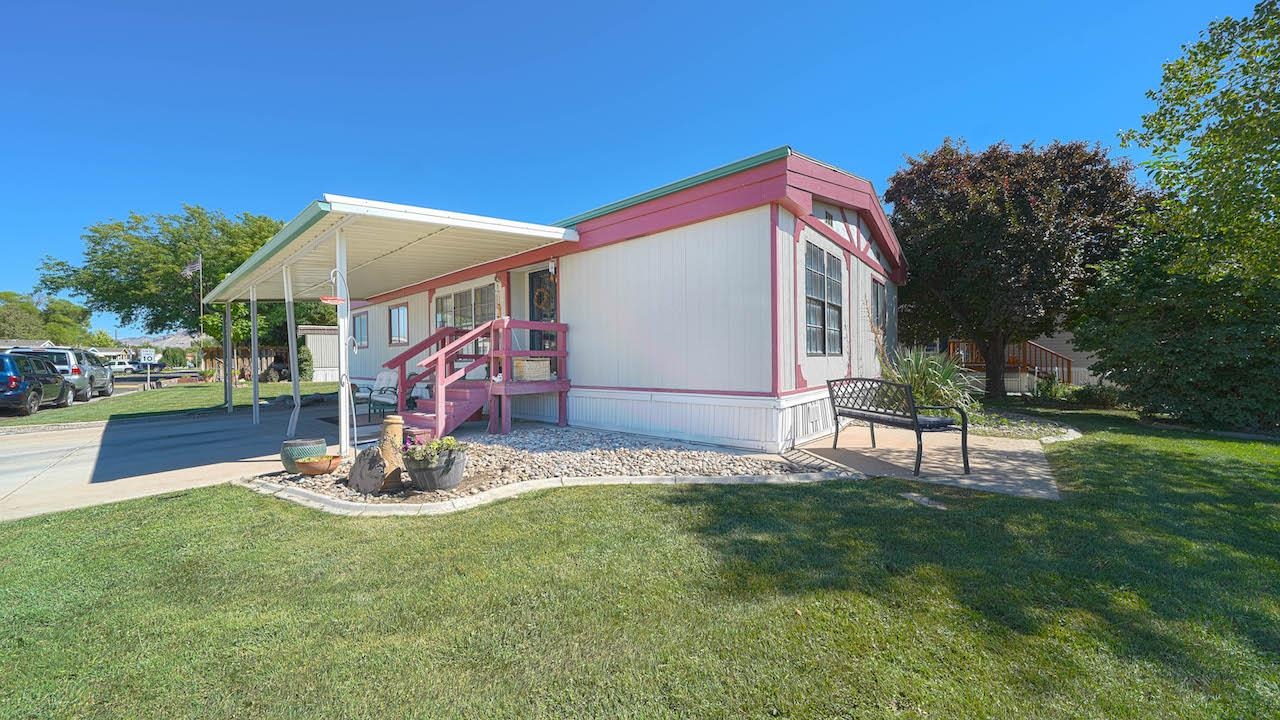 3251 E Road, Unit 100 Clifton, CO 81520 - Photo 21 of 22 a backyard of a house with table and chairs