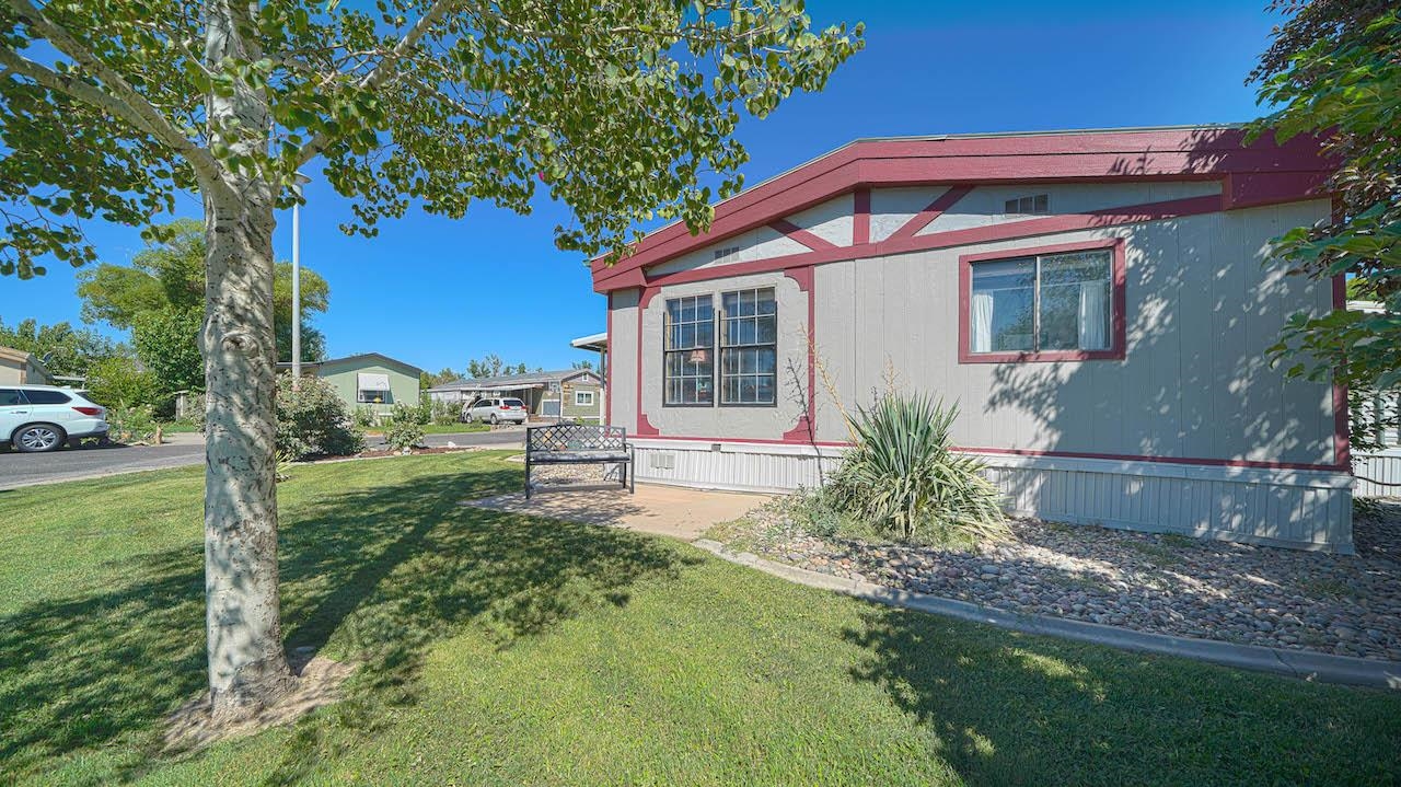 3251 E Road, Unit 100 Clifton, CO 81520 - Photo 22 of 22 a front view of house with yard and trees