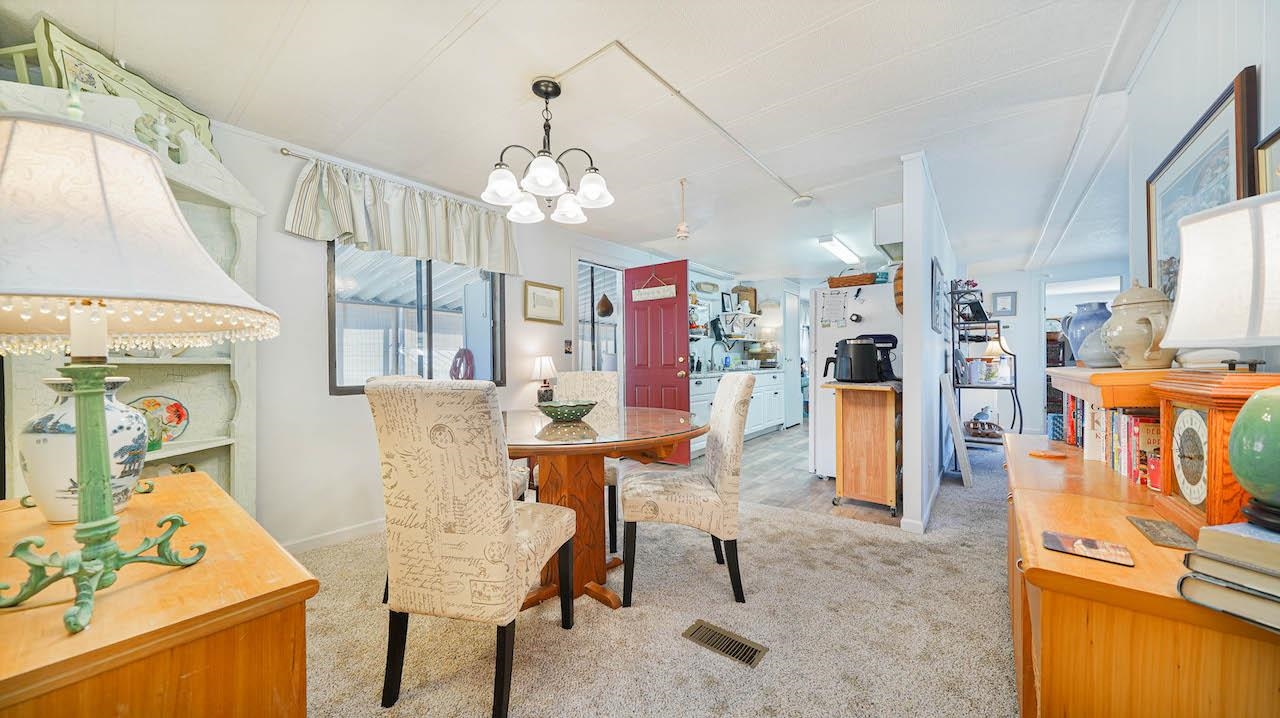 3251 E Road, Unit 100 Clifton, CO 81520 - Photo 4 of 22 a living room with furniture and a chandelier