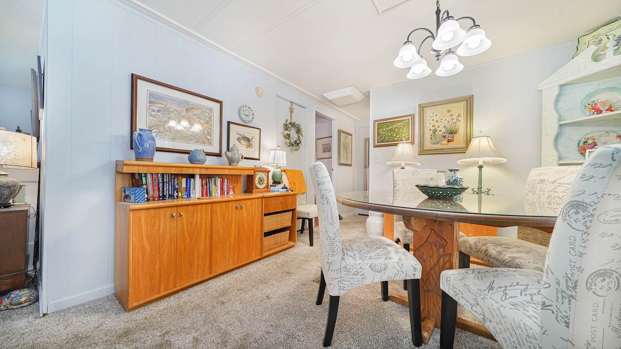 3251 E Road, Unit 100 Clifton, CO 81520 - Photo 6 of 22 a view of a dining room with furniture a chandelier and wooden floor