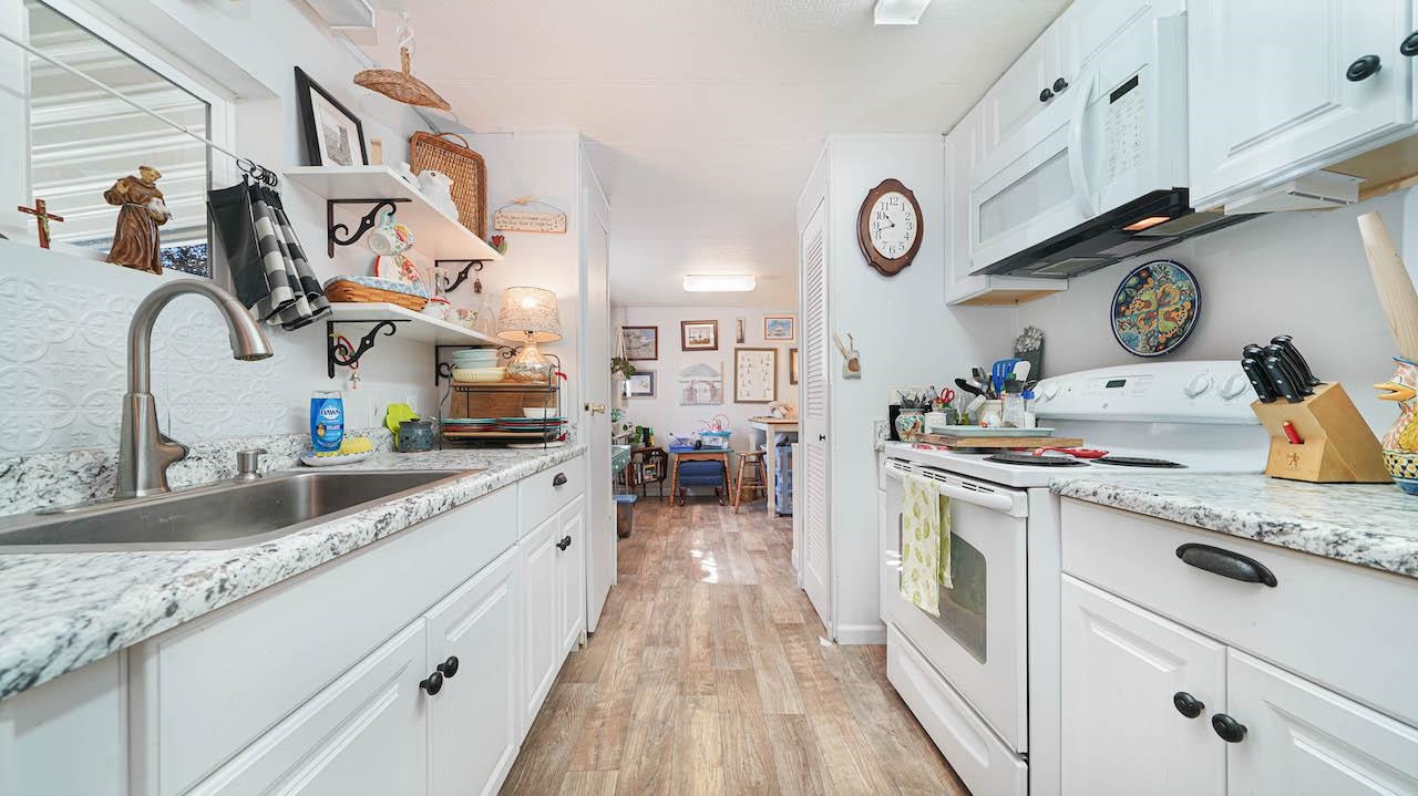 3251 E Road, Unit 100 Clifton, CO 81520 - Photo 7 of 22 a kitchen with kitchen island granite countertop lots of counter top space