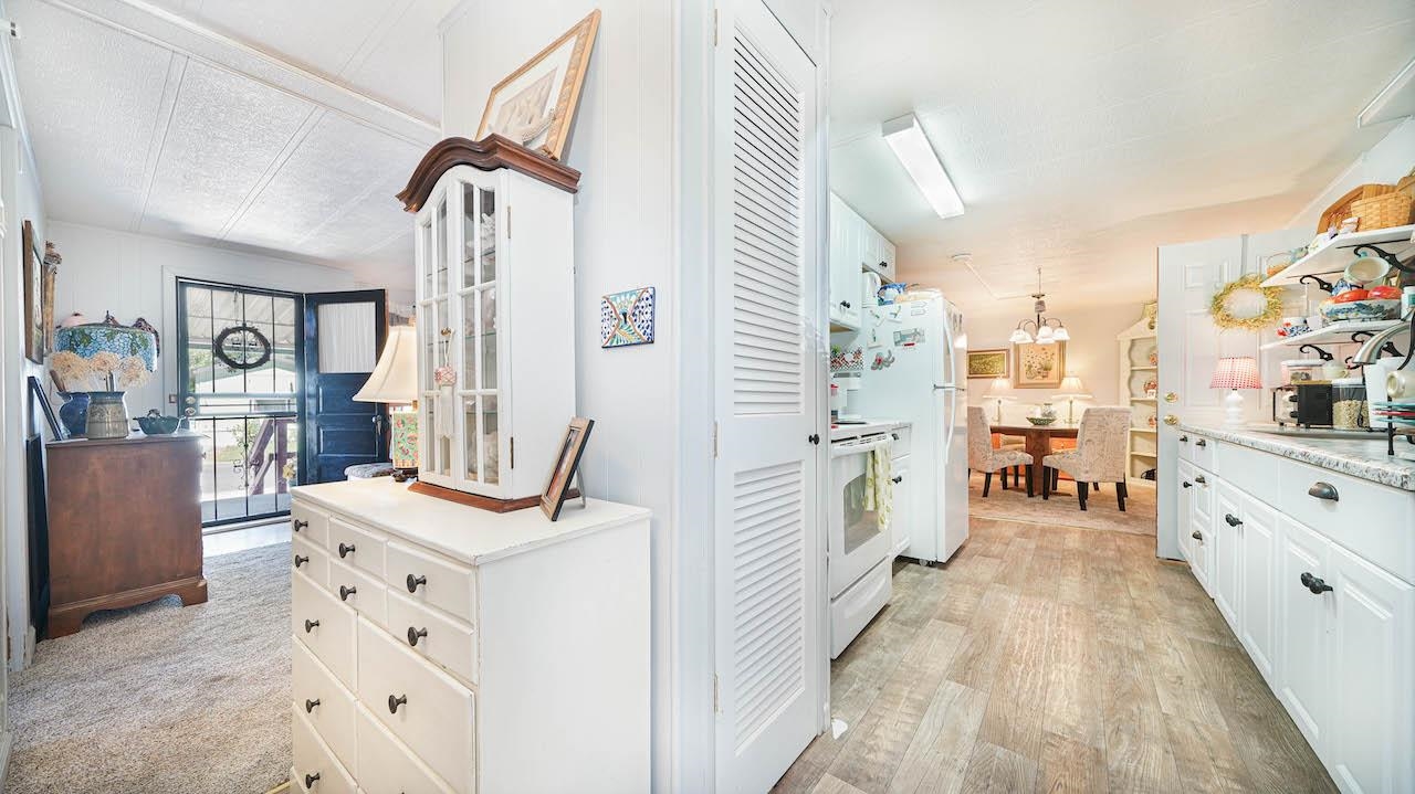 3251 E Road, Unit 100 Clifton, CO 81520 - Photo 8 of 22 a kitchen with white cabinets and white appliances
