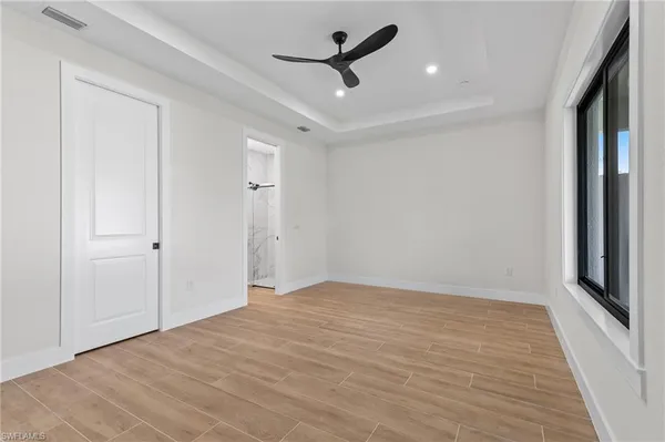 wooden floor in an empty room with a window
