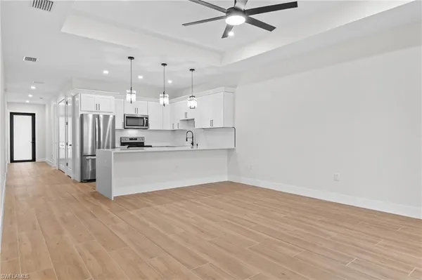 a view of kitchen with stainless steel appliances cabinets