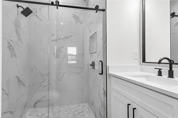 a bathroom with a shower and a sink