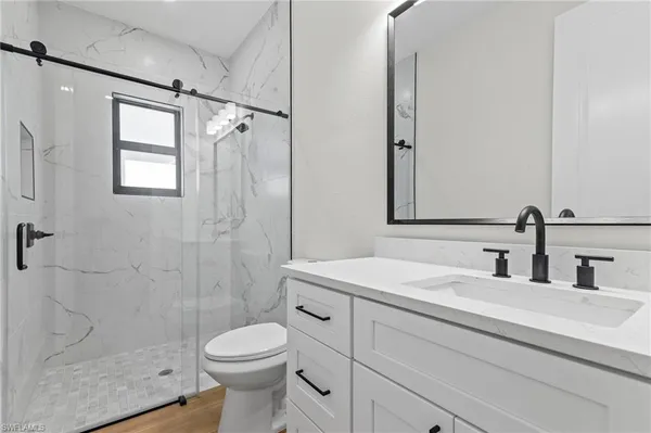 a bathroom with a sink toilet and shower
