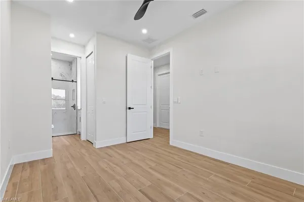 a view of empty room with wooden floor
