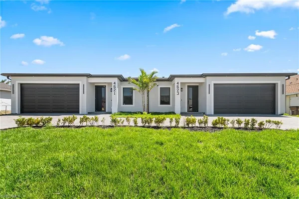 a front view of house with a garden