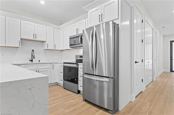 a kitchen with stainless steel appliances a refrigerator stove and sink