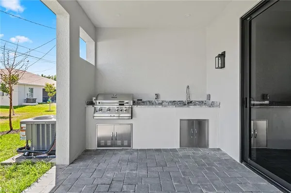 a view of kitchen with refrigerator sink and cabinets